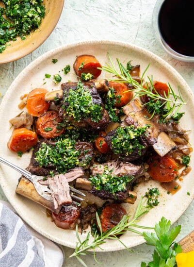 Fall-apart tender beef short ribs with gremolata feature red wine-braised short ribs cooked for hours until tender and topped with a fresh, herby gremolata topping.