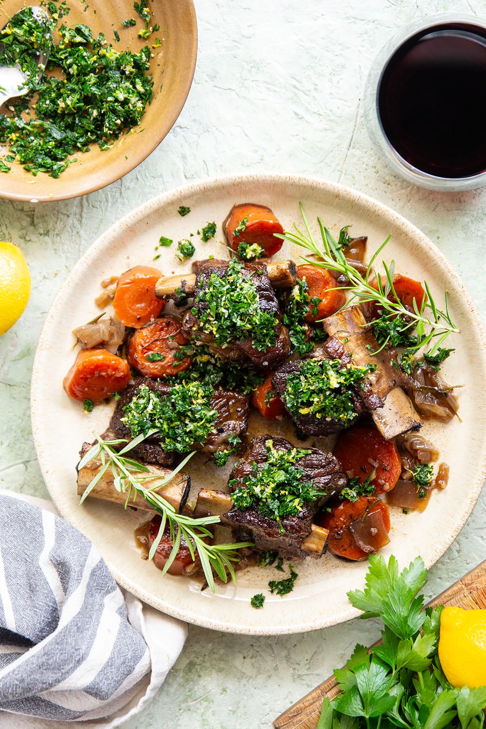 Fall-apart tender beef short ribs with gremolata feature red wine-braised short ribs cooked for hours until tender and topped with a fresh, herby gremolata topping.