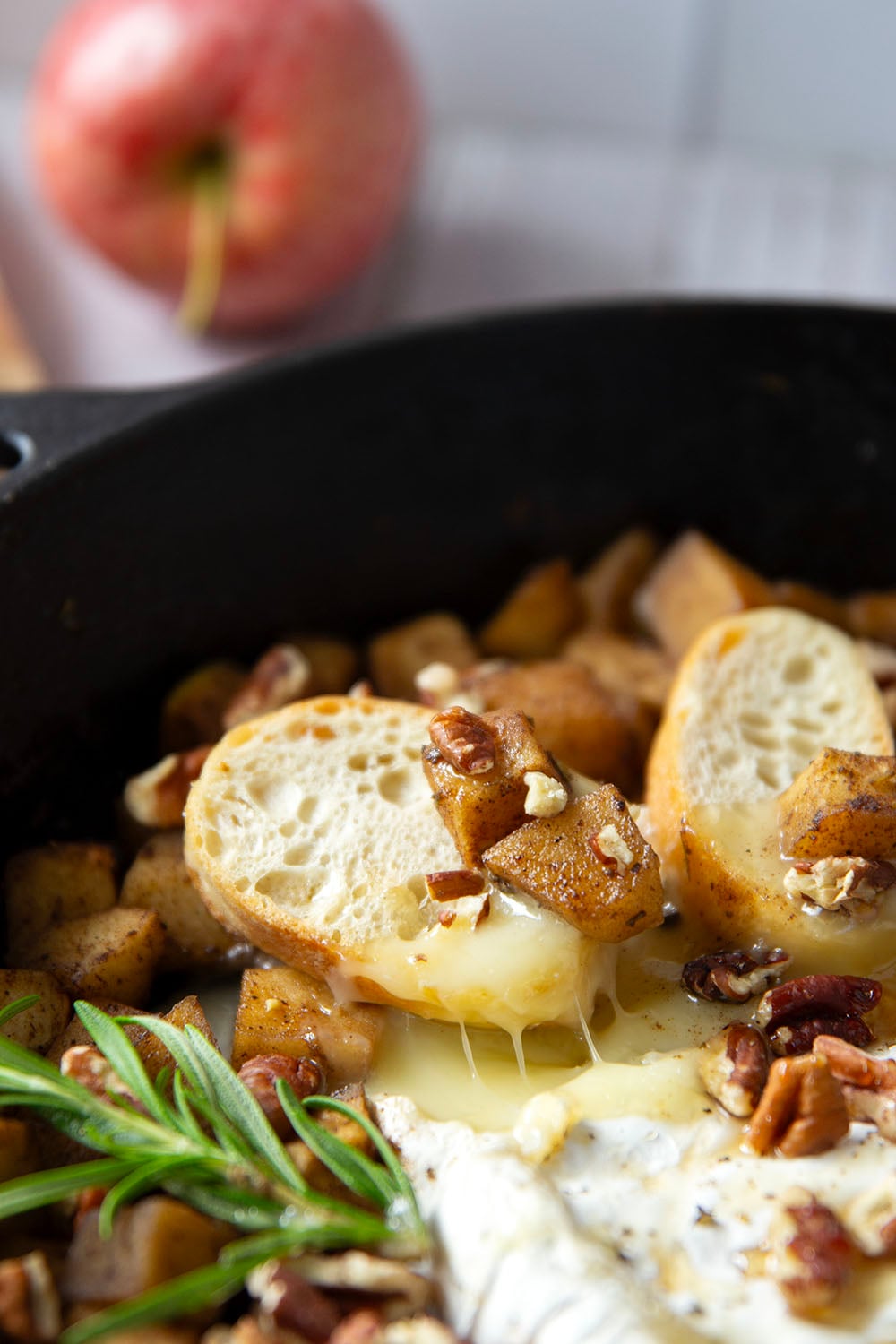 Honey-roasted apples and gooey brie make for the dream team in this honey apple baked brie that's always a hit appetizer with crostini for dipping.