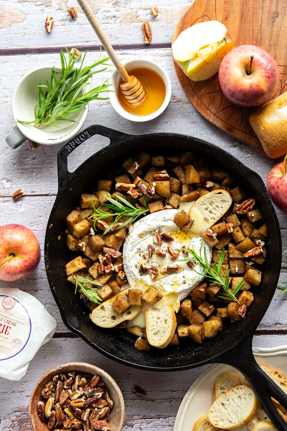 Honey-roasted apples and gooey brie make for the dream team in this honey apple baked brie that's always a hit appetizer with crostini for dipping.