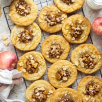 These caramel apple pie cookies feature a soft and chewy butter cookie base with a caramelized apple center, rich drizzles of caramel sauce, and crushed cinnamon crunch cereal on top.