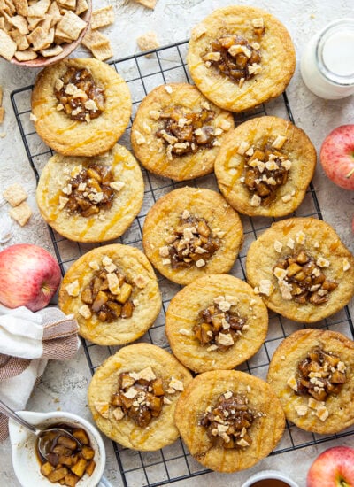 These caramel apple pie cookies feature a soft and chewy butter cookie base with a caramelized apple center, rich drizzles of caramel sauce, and crushed cinnamon crunch cereal on top.