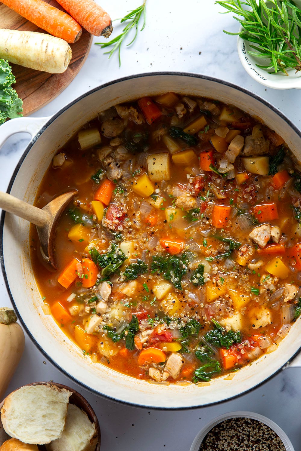 Warm and cozy bowls of quinoa chicken soup feature fall vegetables, lots of fluffy quinoa, and tender chicken cubes in a rich, flavorful broth.