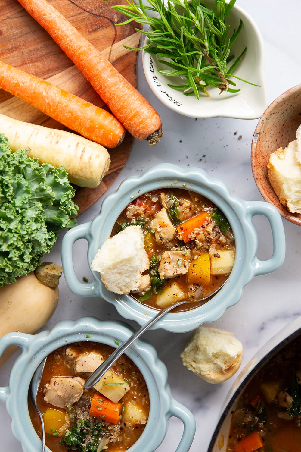 Warm and cozy bowls of quinoa chicken soup feature fall vegetables, lots of fluffy quinoa, and tender chicken cubes in a rich, flavorful broth.