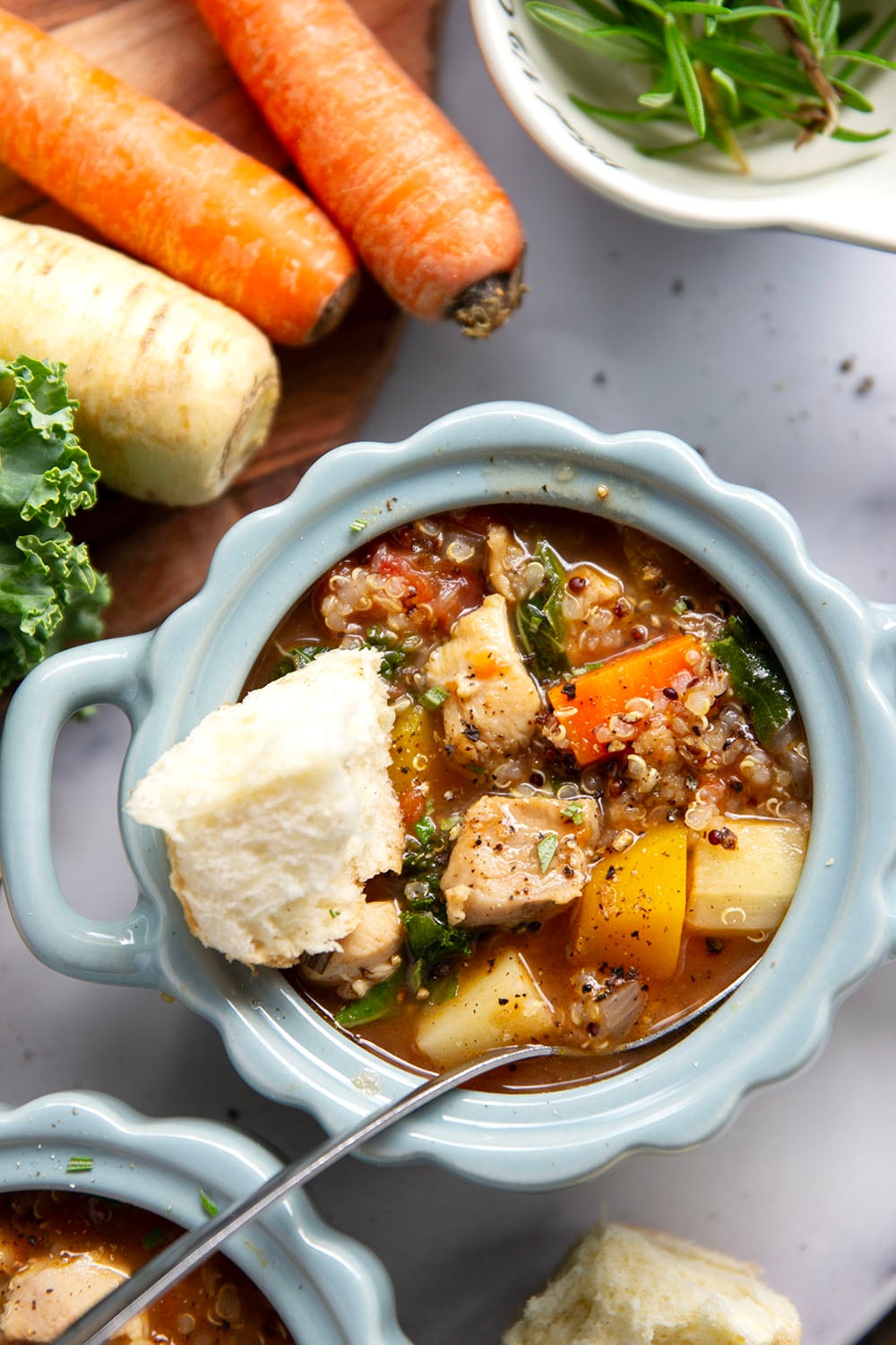Warm and cozy bowls of quinoa chicken soup feature fall vegetables, lots of fluffy quinoa, and tender chicken cubes in a rich, flavorful broth.