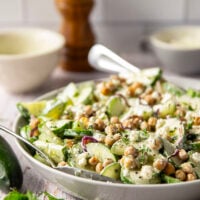 Crispy roasted chickpeas, crunchy cucumber slices, and a cool, creamy mint dressing work incredibly well together in this quick and easy chickpea cucumber salad.