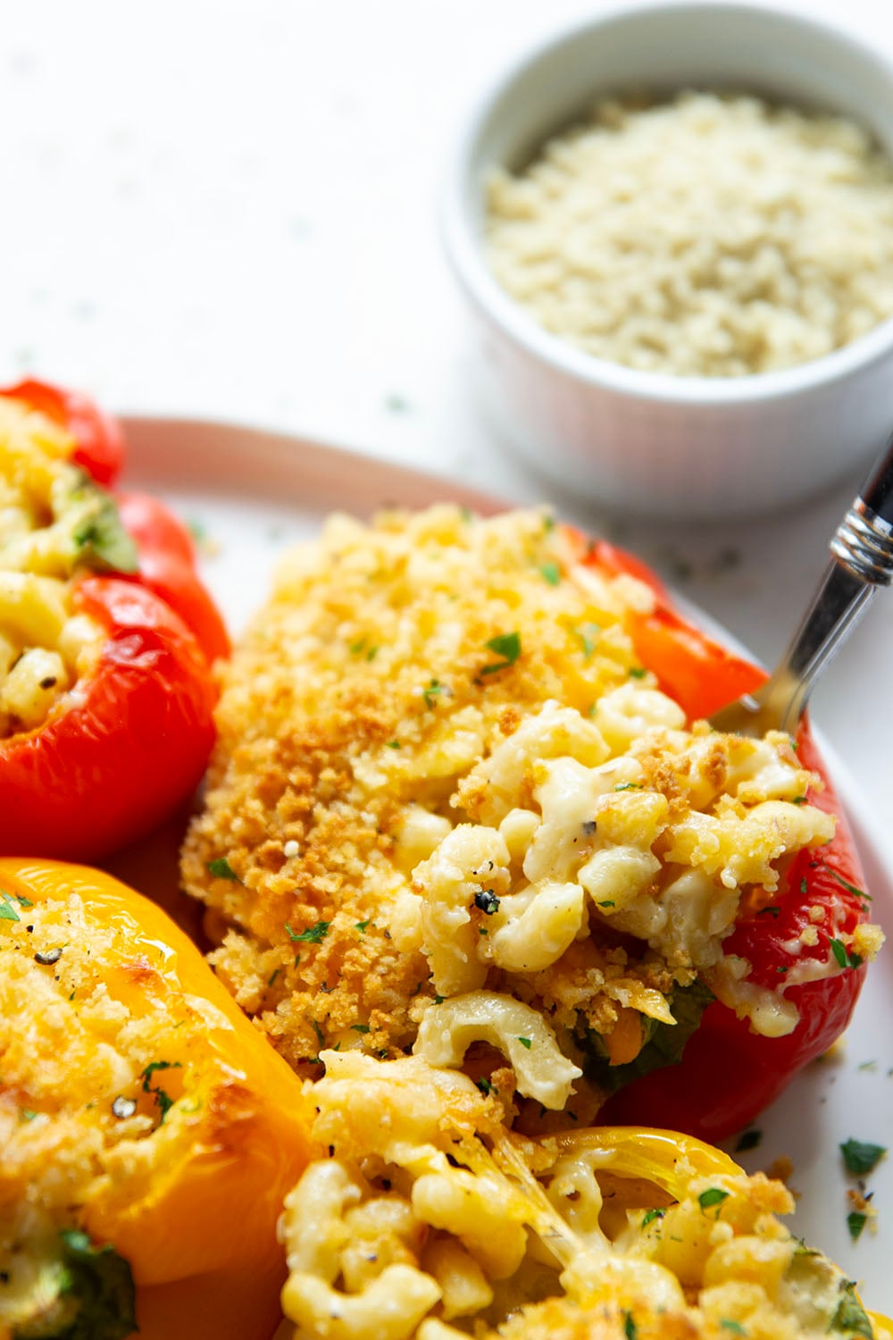 Rich and cheesy mac and cheese stuffed peppers feature tender sweet peppers stuffed with creamy mac and cheese with lots of crispy breadcrumbs on top.