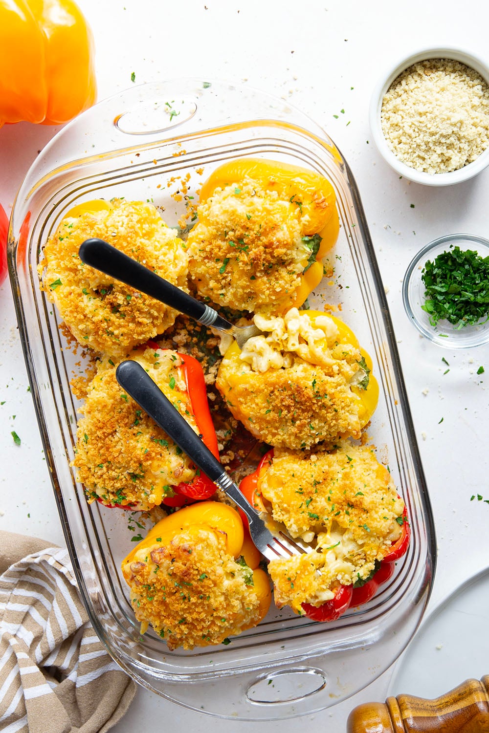 Rich and cheesy mac and cheese stuffed peppers feature tender sweet peppers stuffed with creamy mac and cheese with lots of crispy breadcrumbs on top.