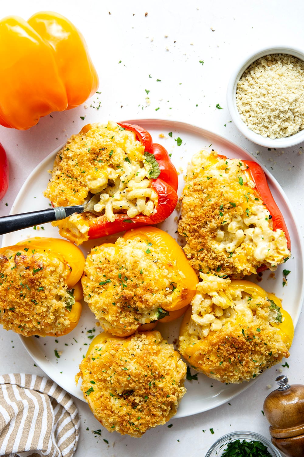 Rich and cheesy mac and cheese stuffed peppers feature tender sweet peppers stuffed with creamy mac and cheese with lots of crispy breadcrumbs on top.