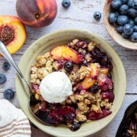 This peach blueberry crisp is all of summer's finest in one pan! Juicy peaches and blueberries, a crispy oatmeal streusel on top, and that obligatory scoop of vanilla ice cream.