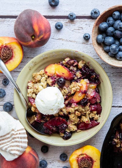 This peach blueberry crisp is all of summer's finest in one pan! Juicy peaches and blueberries, a crispy oatmeal streusel on top, and that obligatory scoop of vanilla ice cream.