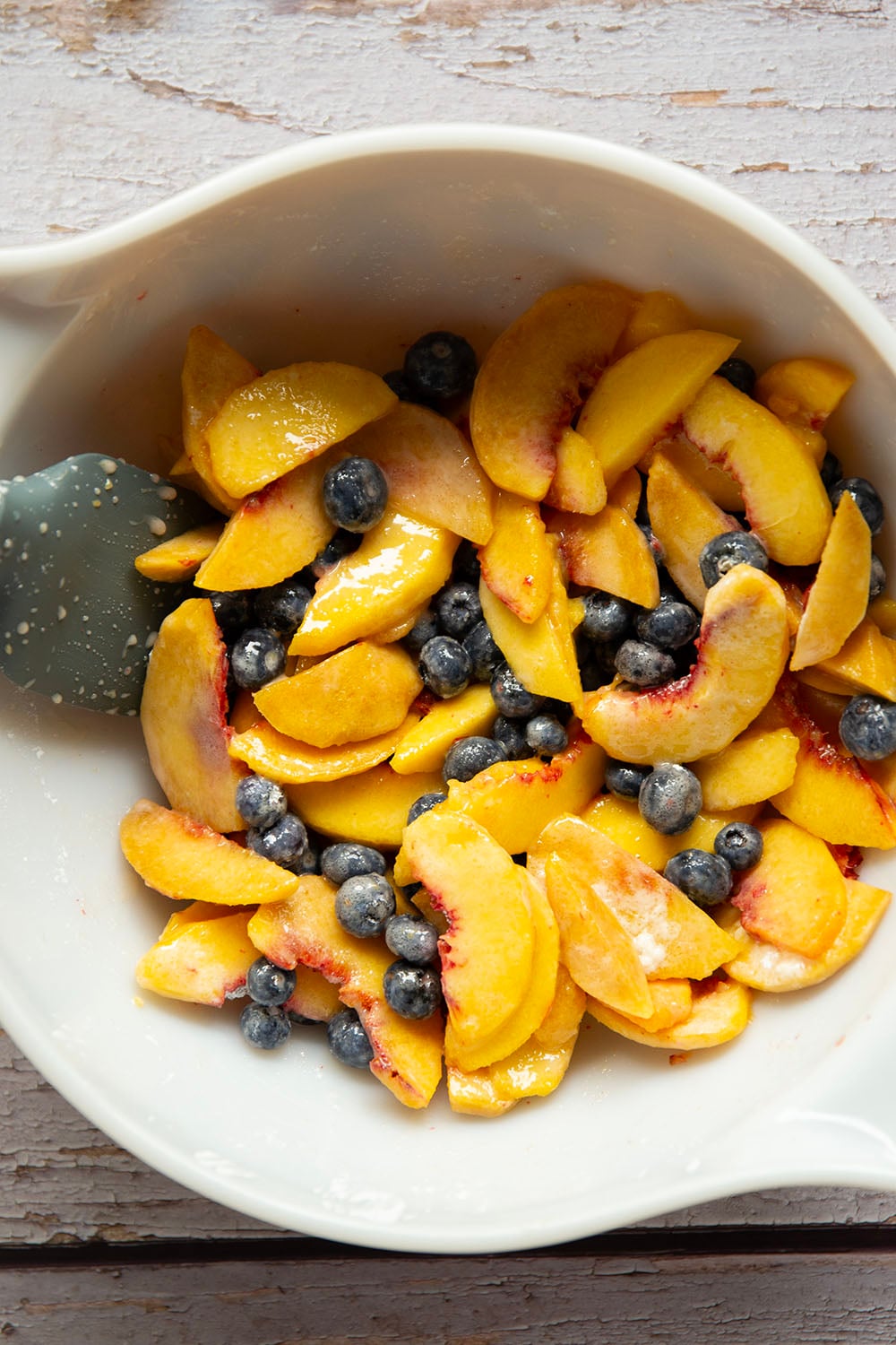 This peach blueberry crisp is all of summer's finest in one pan! Juicy peaches and blueberries, a crispy oatmeal streusel on top, and that obligatory scoop of vanilla ice cream.