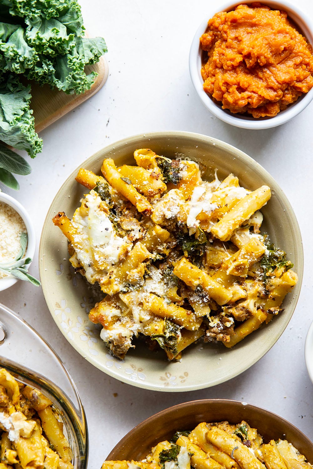 Baked in a creamy pumpkin white sauce with two kinds of cheese and tender sausage bits, this pumpkin baked ziti is a fun fall twist on the classic comfort dish.