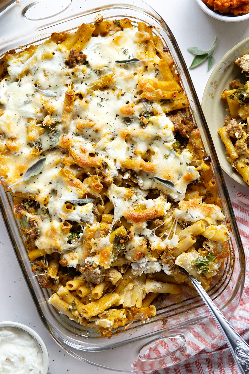 Baked in a creamy pumpkin white sauce with two kinds of cheese and tender sausage bits, this pumpkin baked ziti is a fun fall twist on the classic comfort dish.