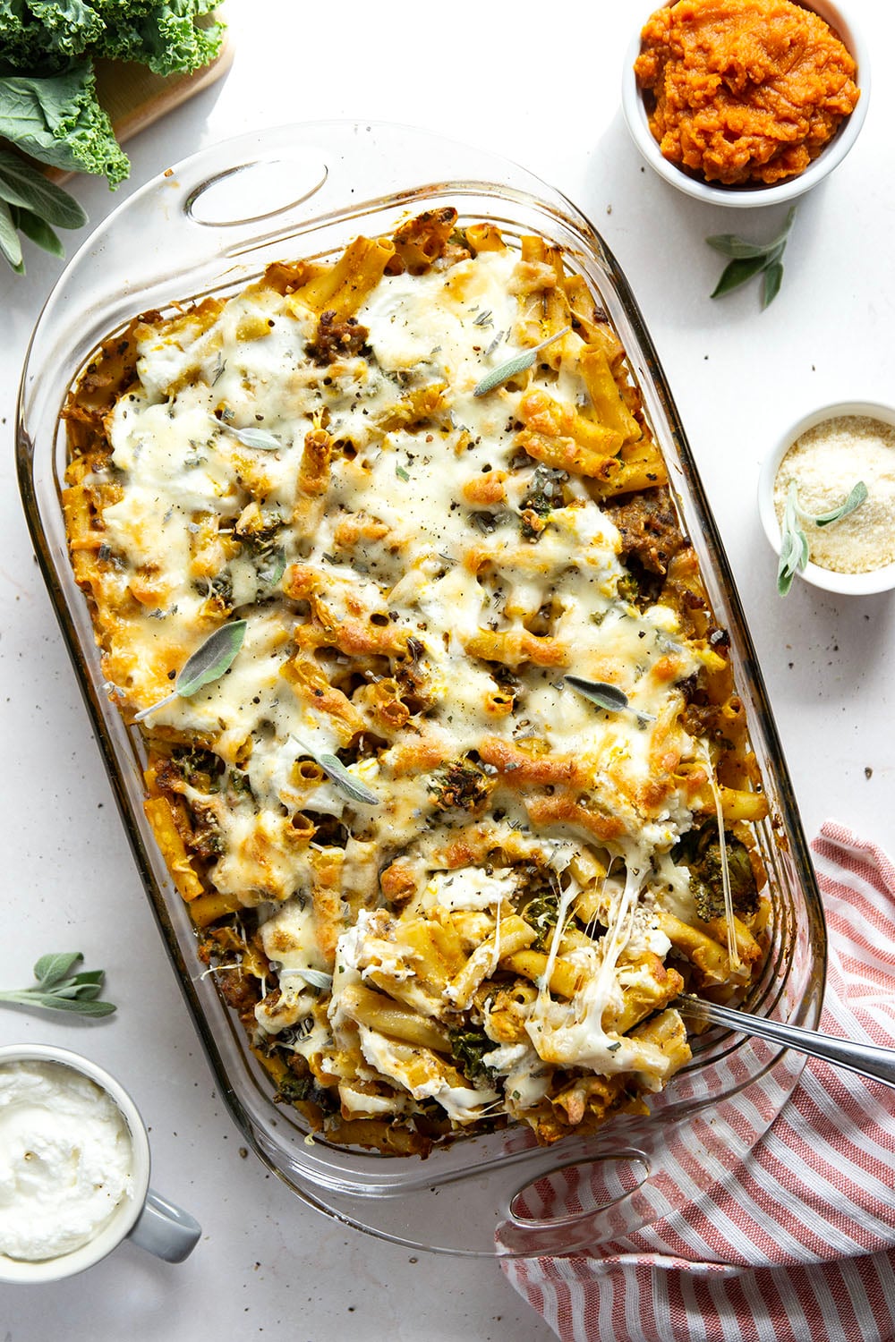 Baked in a creamy pumpkin white sauce with two kinds of cheese and tender sausage bits, this pumpkin baked ziti is a fun fall twist on the classic comfort dish.
