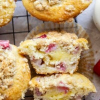Packed with juicy strawberries, filled with a luscious cheesecake filling, and topped with a buttery crumb topping, these strawberry cheesecake muffins are the best of all worlds wrapped up into one muffin.