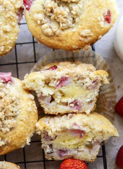 Packed with juicy strawberries, filled with a luscious cheesecake filling, and topped with a buttery crumb topping, these strawberry cheesecake muffins are the best of all worlds wrapped up into one muffin.