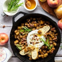 Honey-roasted apples and gooey brie make for the dream team in this honey apple baked brie that's always a hit appetizer with crostini for dipping.
