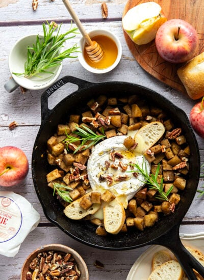 Honey-roasted apples and gooey brie make for the dream team in this honey apple baked brie that's always a hit appetizer with crostini for dipping.