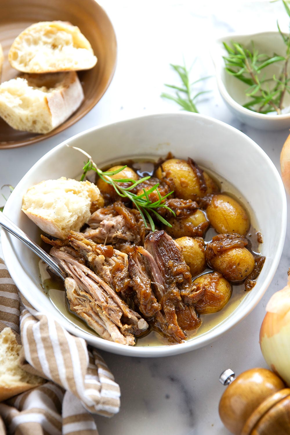Braised for hours in a caramelized onion sauce with lots of hearty potatoes, this braised pork shoulder cooks up fall-apart tender and makes a great meat entree for any occasion.