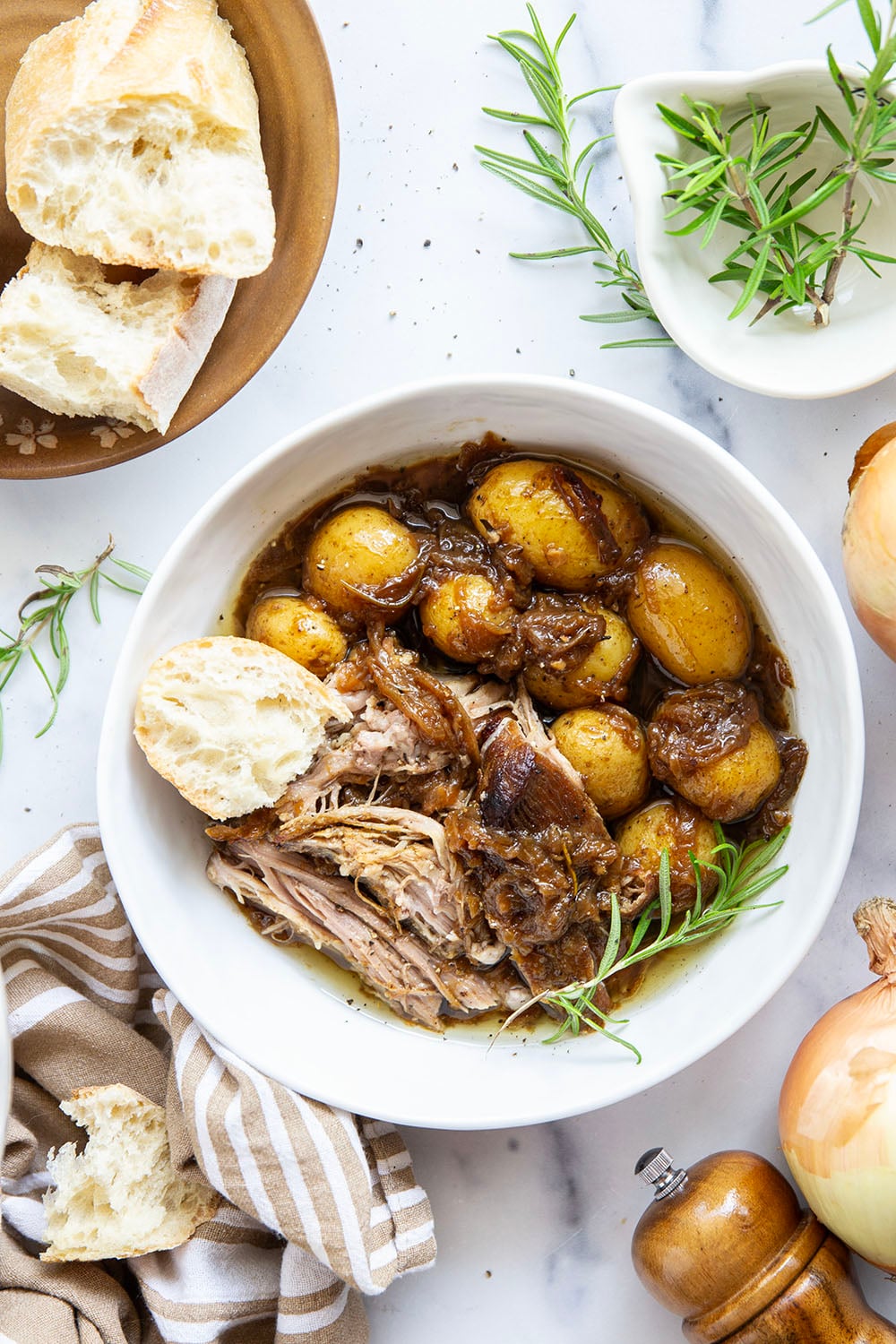 Braised for hours in a caramelized onion sauce with lots of hearty potatoes, this braised pork shoulder cooks up fall-apart tender and makes a great meat entree for any occasion.