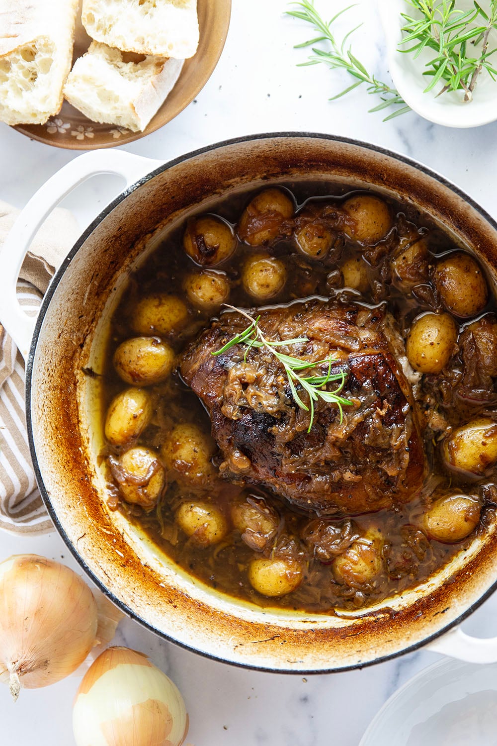 Braised for hours in a caramelized onion sauce with lots of hearty potatoes, this braised pork shoulder cooks up fall-apart tender and makes a great meat entree for any occasion.