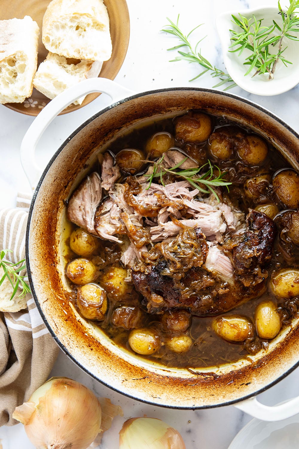 Braised for hours in a caramelized onion sauce with lots of hearty potatoes, this braised pork shoulder cooks up fall-apart tender and makes a great meat entree for any occasion.