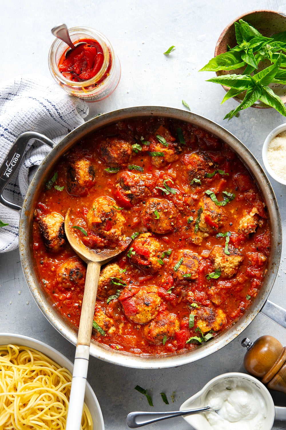 Moist and tender chicken ricotta meatballs are simmered in a flavorful roasted red pepper tomato sauce and are amazing served over spaghetti with lots of Parmesan and basil on top.