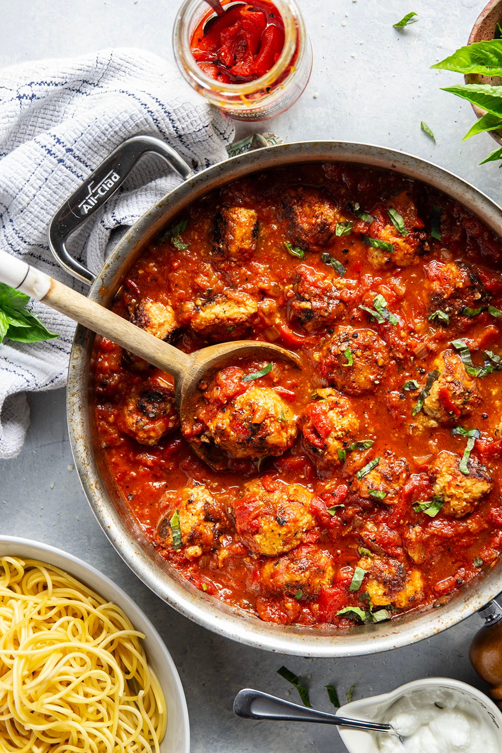 Moist and tender chicken ricotta meatballs are simmered in a flavorful roasted red pepper tomato sauce and are amazing served over spaghetti with lots of Parmesan and basil on top.