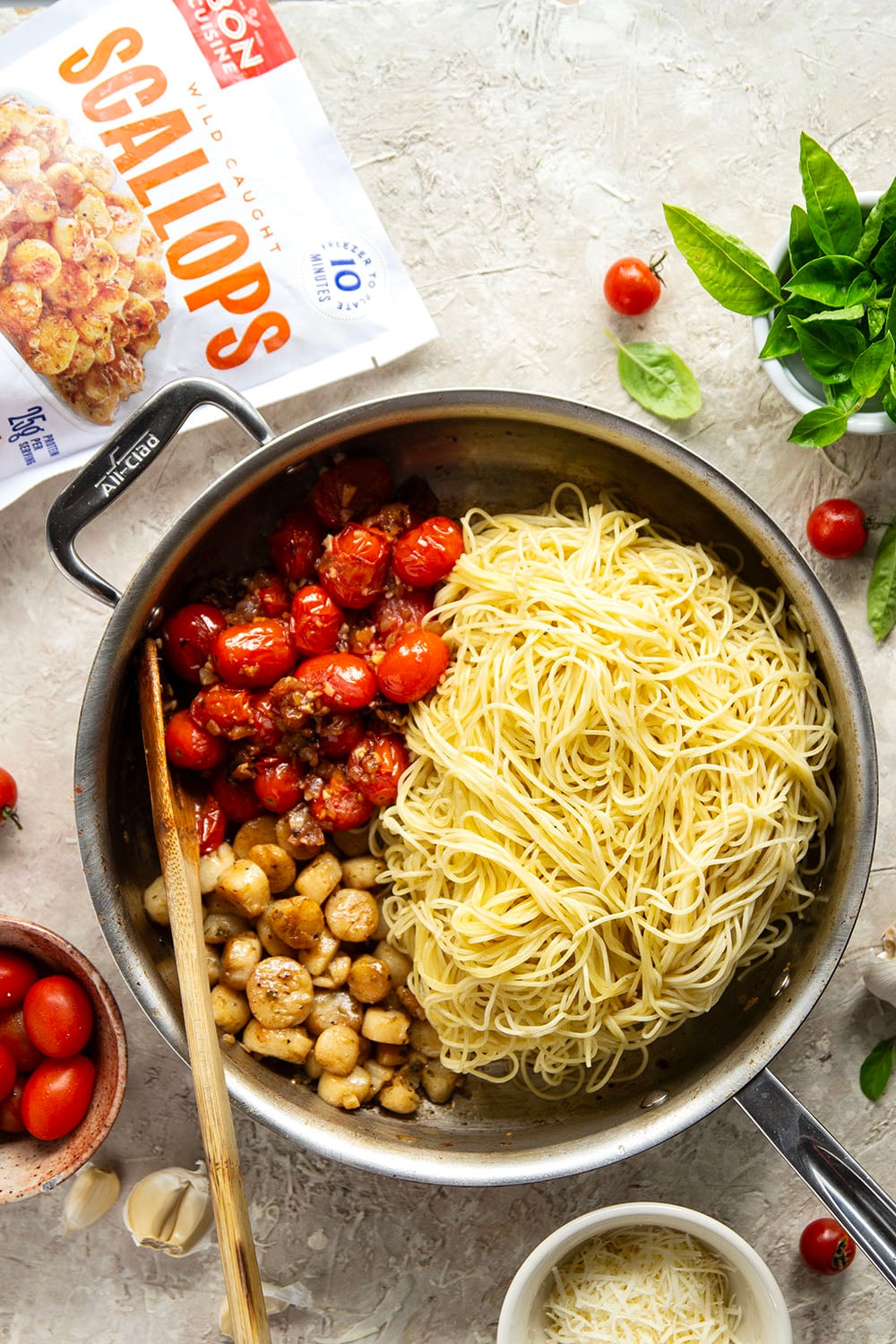 Garlicky scallops, bursting tomatoes, and lots of fresh Parmesan cheese star in this garlic Parmesan scallop pasta that comes together in minutes for an elevated weeknight meal.