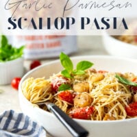 Garlicky scallops, bursting tomatoes, and lots of fresh Parmesan cheese star in this garlic Parmesan scallop pasta that comes together in minutes for an elevated weeknight meal.