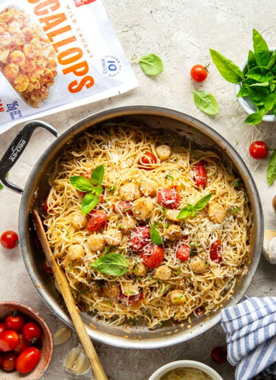 Garlicky scallops, bursting tomatoes, and lots of fresh Parmesan cheese star in this garlic Parmesan scallop pasta that comes together in minutes for an elevated weeknight meal.