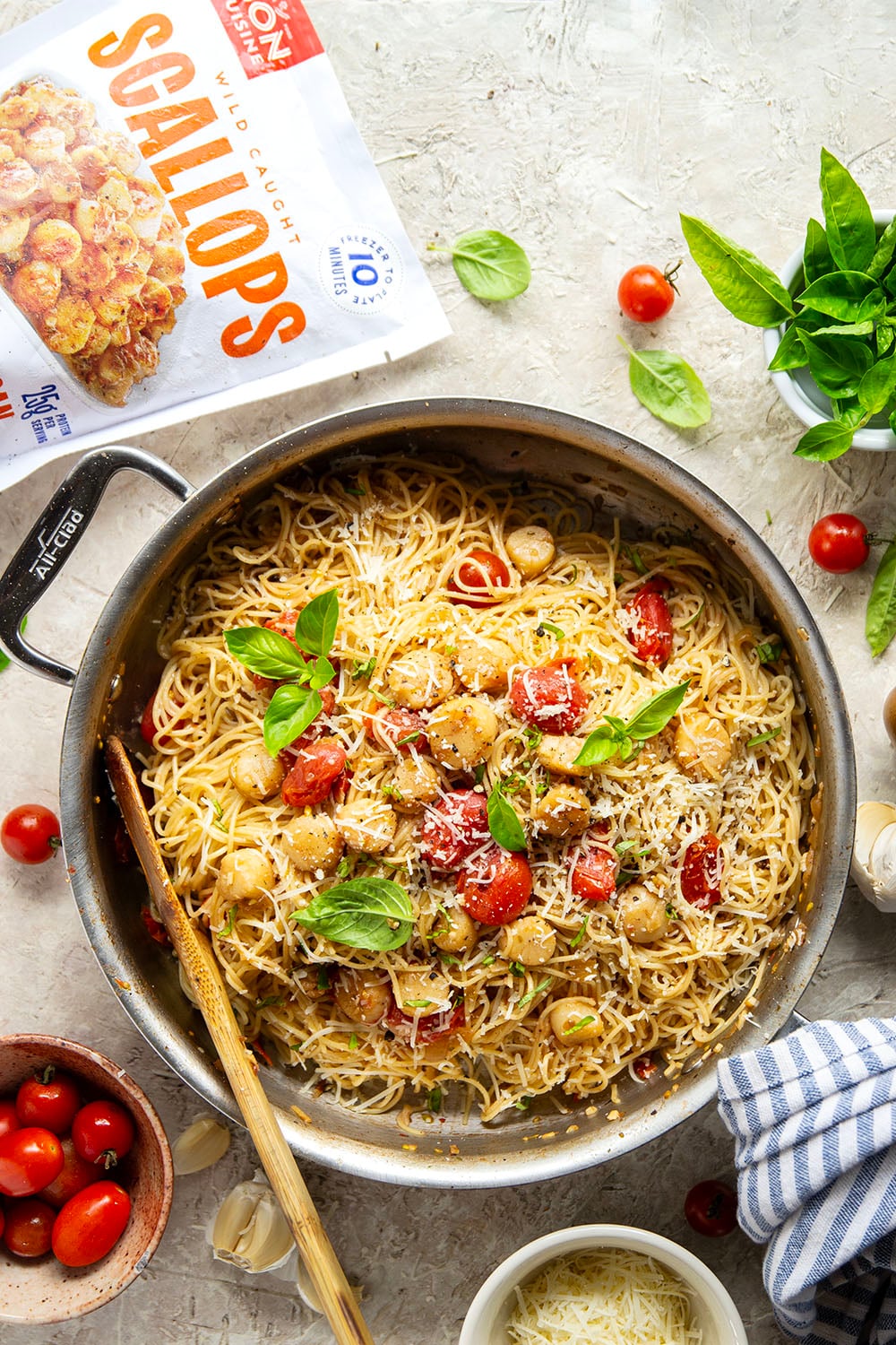 Garlicky scallops, bursting tomatoes, and lots of fresh Parmesan cheese star in this garlic Parmesan scallop pasta that comes together in minutes for an elevated weeknight meal.