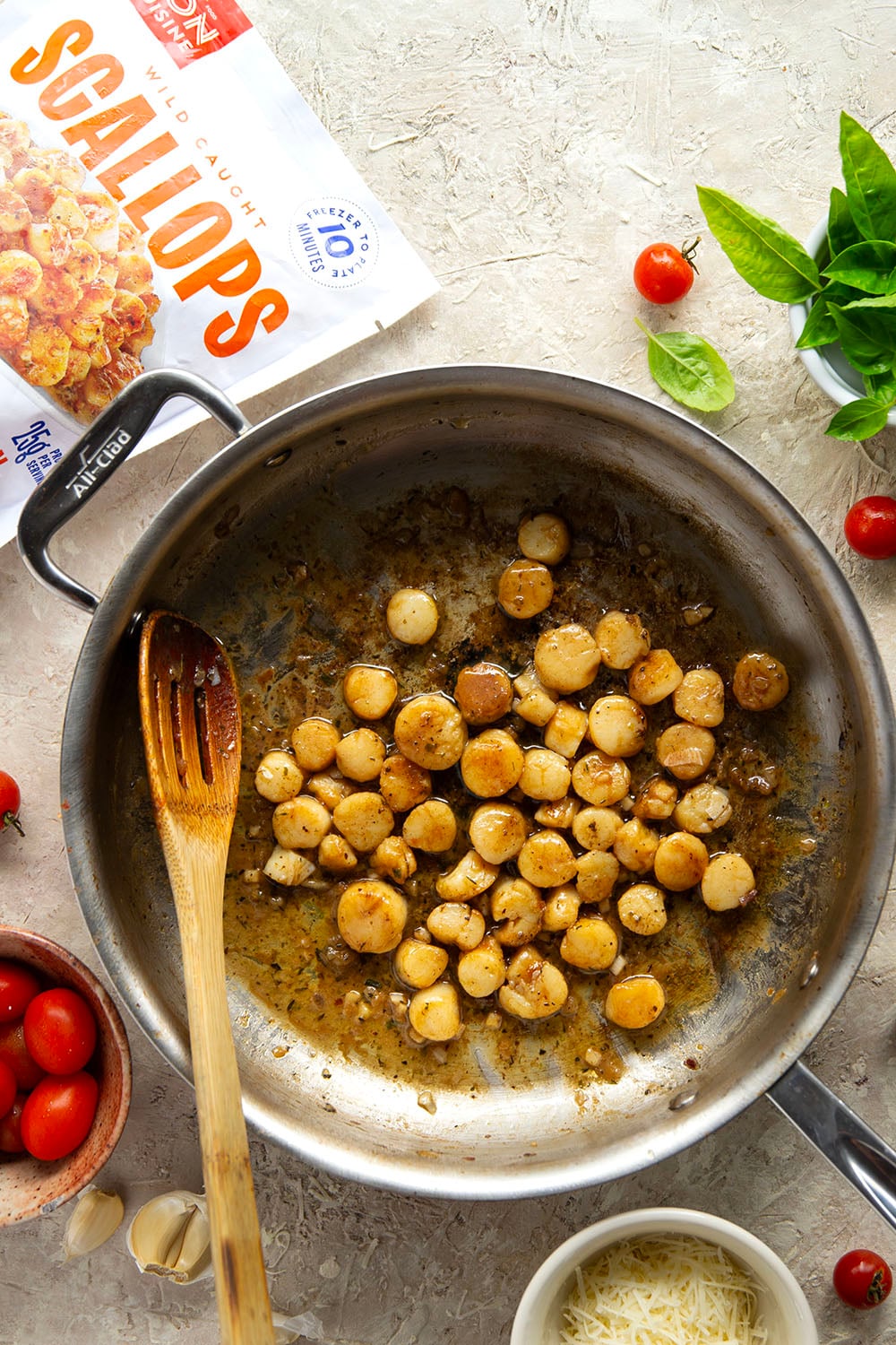 Garlicky scallops, bursting tomatoes, and lots of fresh Parmesan cheese star in this garlic Parmesan scallop pasta that comes together in minutes for an elevated weeknight meal.