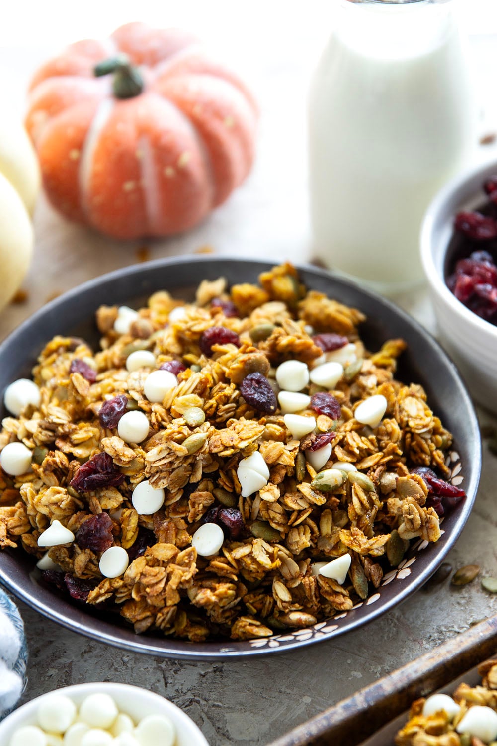 This crisp pumpkin granola has a delightful fall twist of warming spices, real pumpkin puree, white chocolate, and dried cranberries.